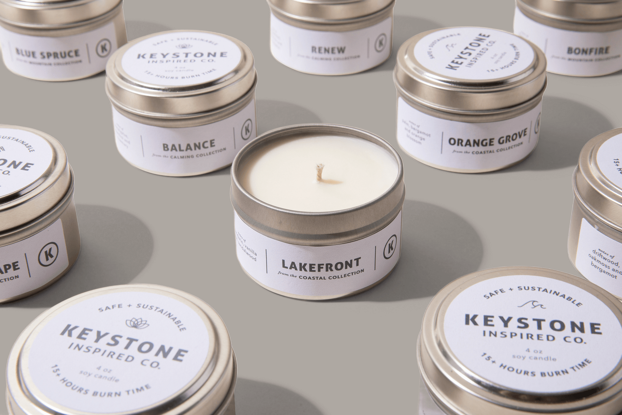 Collection of Keystone Inspired Co. candles with various scents on a neutral background