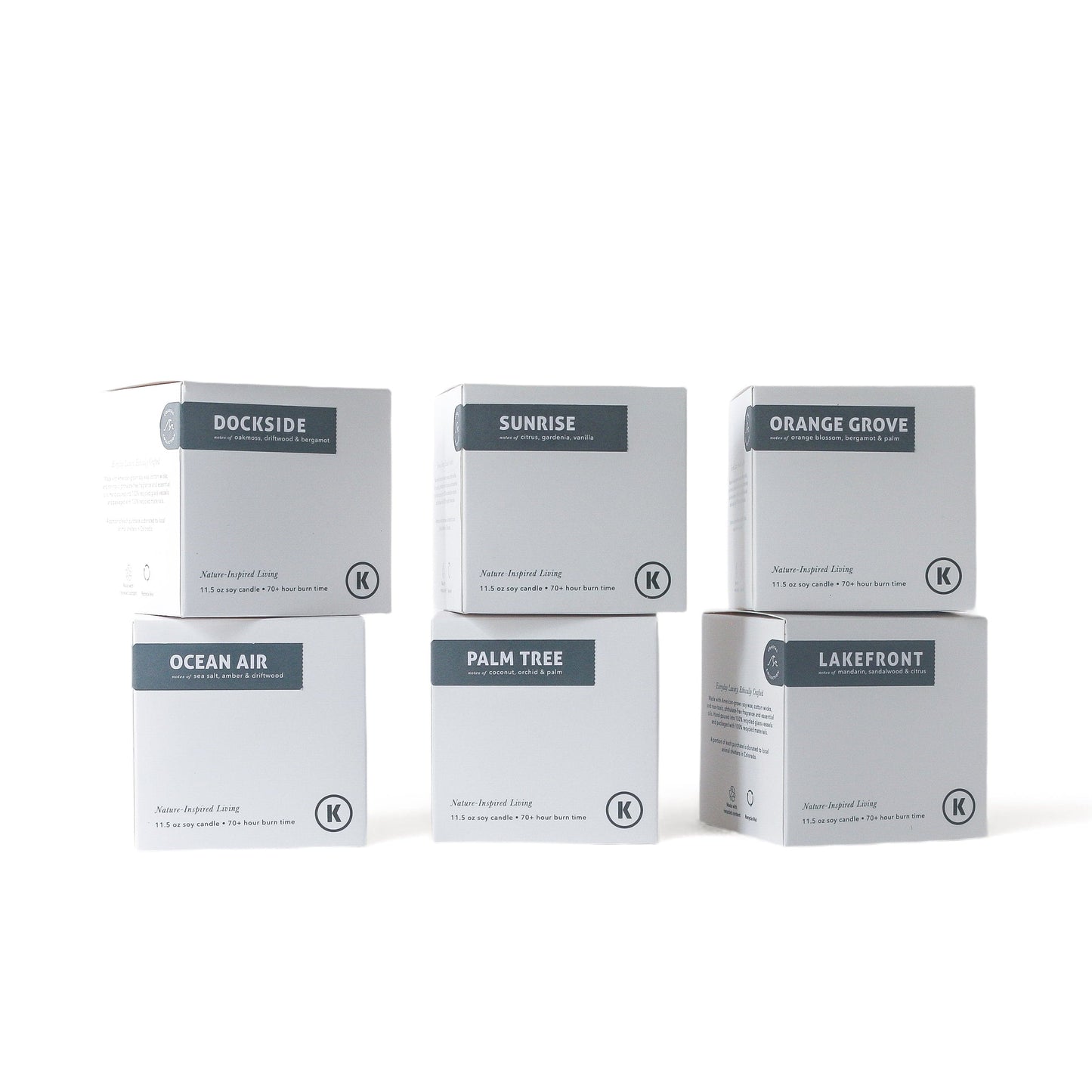 Six boxes of different scented candles on a white background